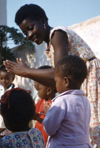 teacher with happy children clapping